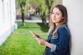 Young girl standing on the college campus yard with the tablet Royalty Free Stock Photo