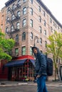 Young guy is standing on the corner of Bedford Street with Grove Street in Greenwich Village Royalty Free Stock Photo