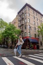 Young girl is standing on the corner of Bedford Street with Grove Street in Greenwich Village Royalty Free Stock Photo