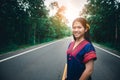 Young girl standing and enjoy fresh air on road at countryside of Thailand Royalty Free Stock Photo