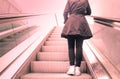 Young girl standing on escalators stairway