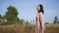 Young girl standing at field grass and blue sky Royalty Free Stock Photo