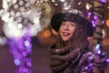 Young girl standing in front of christmas tree lights at night w Royalty Free Stock Photo