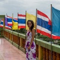 Young girl standing in front of row of flags Royalty Free Stock Photo