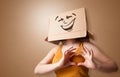Young girl with happy cardboard box face