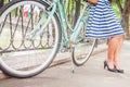 Young girl standing near fence near vintage bike at park Royalty Free Stock Photo