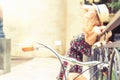 Young girl standing near fence, near vintage city bike Royalty Free Stock Photo