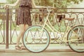 Young girl standing near fence, near vintage city bike Royalty Free Stock Photo