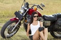 Young girl standing near a motorcycle Royalty Free Stock Photo