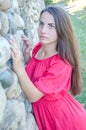 Young girl standing near a stone wall Royalty Free Stock Photo