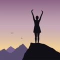 Young girl standing on rock and enjoying success in mountain lan Royalty Free Stock Photo