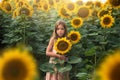 Girl standing in sunflower field and holding sunflower Royalty Free Stock Photo