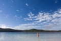 Young girl standing in the tranquil lake