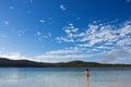 Young girl standing in the tranquil lake