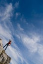 A young girl stands on the edge of a cliff Royalty Free Stock Photo