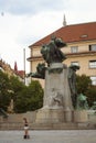 A young girl stands at the foot of the monument of Frantisek Pal