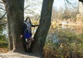 young girl stands near river in city park on autumn day Royalty Free Stock Photo