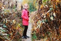 The young girl stands in the woods and smiles, she is glad she found her way home, because before that she was lost and crying Royalty Free Stock Photo