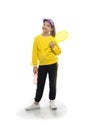 A young girl standsi with a tennis racket and bottled water, Royalty Free Stock Photo