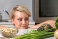 Young girl stares at tortoise eating salad