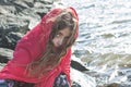 Little Red Riding Hood Girl's Face on the Rocks with Cape Royalty Free Stock Photo