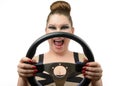 Young girl with a steering wheel on white