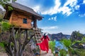 Young girl on steps of house on tree at Atuh beach in Nusa Penida island, Bali in Indonesia.