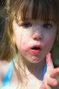 Young girl with sticky cotton candy fingers