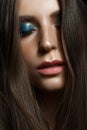 A young girl with straight long hair and bright makeup. Beautiful model with shining skin. Sensual and gentle. Beauty face. Evenin