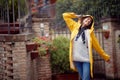A young girl in a street walk is in a good mood while enjoying music and rain. Walk, rain, city Royalty Free Stock Photo