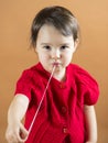 Young girl stretching a chewing gum from her mouth Royalty Free Stock Photo