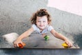 A young girl struggles to climb a game in a playground Royalty Free Stock Photo