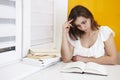 Young girl student reading a book. Attractive girl preparing for exams at university. Royalty Free Stock Photo