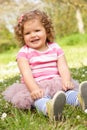 Young Girl In Summer Dress Sitting In Field Royalty Free Stock Photo