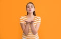 young girl in summer striped tshirt on yellow background. kissing