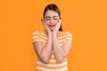 young girl in summer striped tshirt on yellow background. skincare