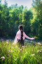 Young girl in summer sunny day walking and dancing in fields flo Royalty Free Stock Photo