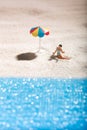 Young girl sunbathing alone on a sandy beach