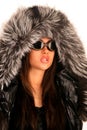 The young girl in sunglasses and a fur hood
