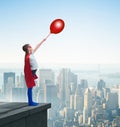 Young girl in superhero costume overlooking the city Royalty Free Stock Photo