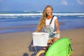Young girl with surfboard and bicycle Royalty Free Stock Photo