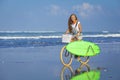 Young girl with surfboard and bicycle Royalty Free Stock Photo