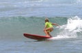 Young Girl Surfing on a Red Surfboard in Hawaii Royalty Free Stock Photo