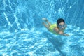 Young girl swimmer swimming under water in pool and has fun, teenager diving underwater, family vacation, sport and fitness Royalty Free Stock Photo