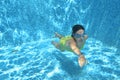 Young girl swimmer swimming under water in pool and has fun, teenager diving underwater, family vacation, sport and fitness Royalty Free Stock Photo