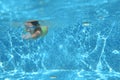 Young girl swimmer swimming under water in pool and has fun, teenager diving underwater, family vacation, sport and fitness Royalty Free Stock Photo