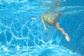 Young girl swimmer swimming under water in pool and has fun, teenager diving underwater, family vacation, sport and fitness Royalty Free Stock Photo