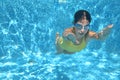 Young girl swimmer swimming under water in pool and has fun, teenager diving underwater, family vacation, sport and fitness Royalty Free Stock Photo