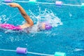 Young girl swimmer working on her freestyle swim at a local pool