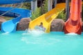 Young girl on swimming pool sliders